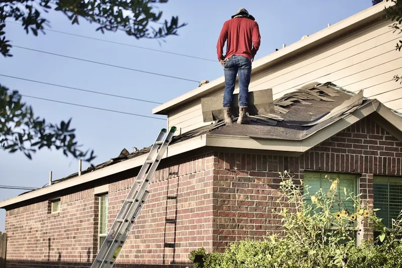 Professional roofer working on a residential roof in North Redlands